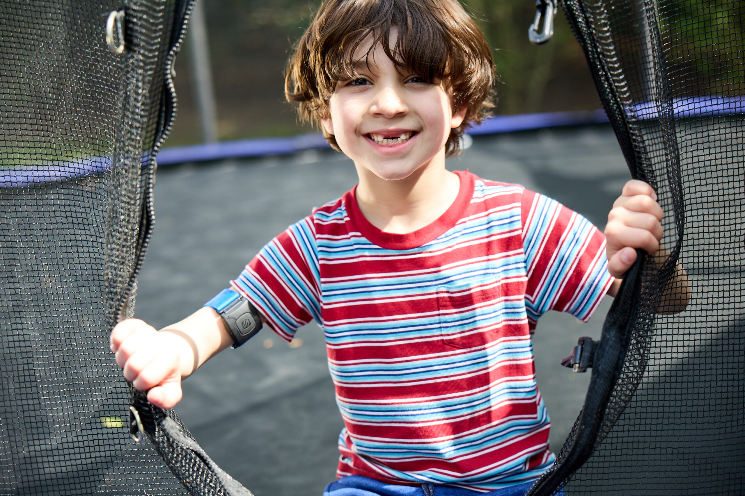boy smiling on trampoline